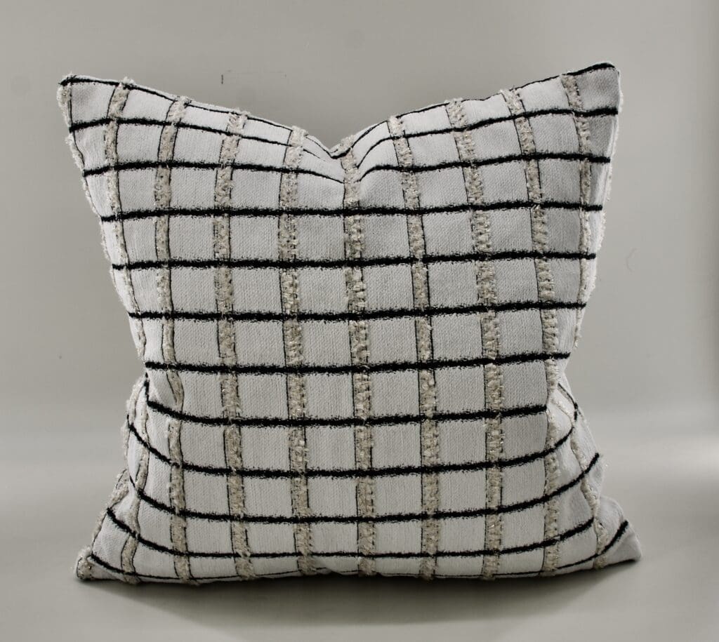 Textured throw pillow in a grid pattern of black and cream, showcasing a modern and stylish accent for home decor.